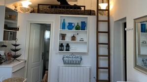 A compact kitchen with a loft bed, a ladder, and a shelf with decorative items. - Near Aix-en-provence, country house, with pool without vis-à-vis (Aix-en-Provence)