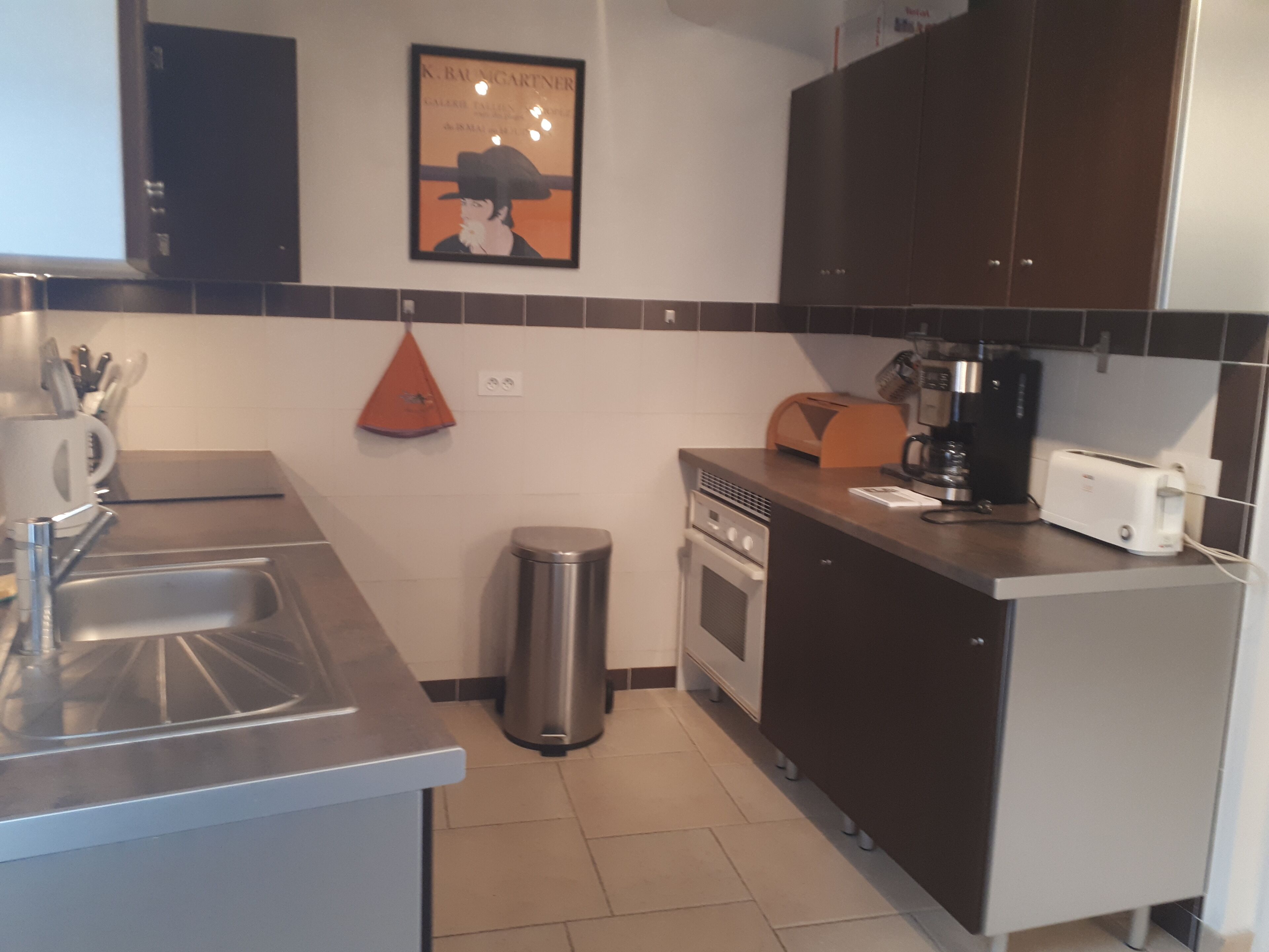 A modern kitchen with stainless steel appliances, a coffee maker, and a toaster.