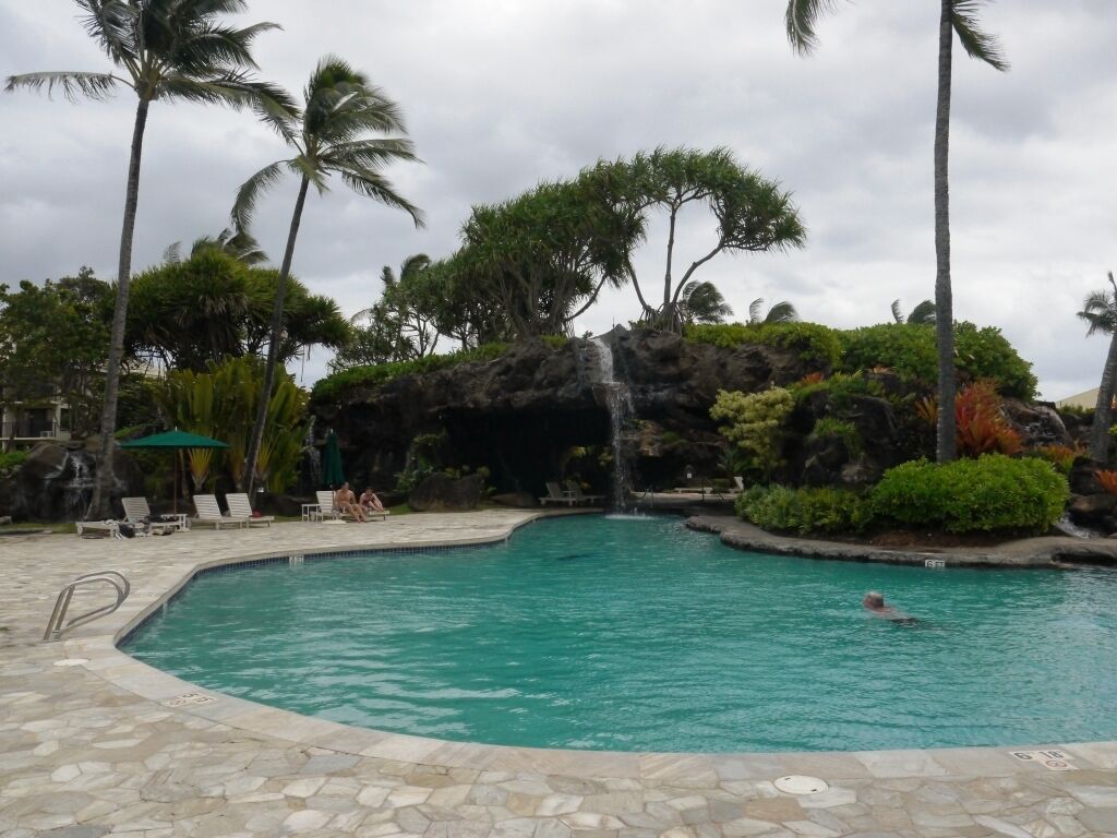 waterfall cascading into pool.