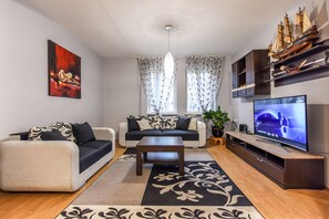Comfort Apartment, 2 Bedrooms | Living area | Flat-screen TV, fireplace