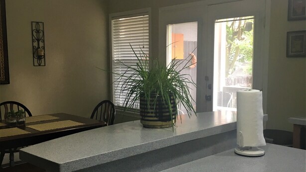 A kitchen with a central island, a ceiling fan, and a potted plant. - Spacious home near all San Antonio Attractions! Karaoke Machine is available (San Antonio)