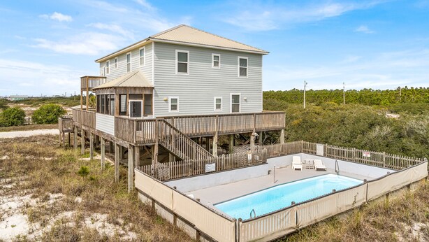 A two-story beach house with a wooden deck and a swimming pool. - Large 6 Bdrm home with amazing Gulf Views, Easy Beach Access, and Private Pool (Gulf Shores)
