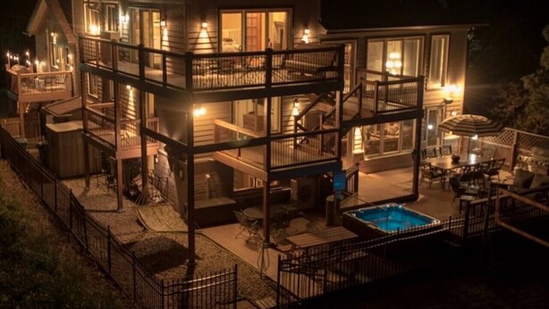 A multi-story house with a pool, outdoor seating, and a fenced patio area. - Panoramic views, Hot Tub, Sauna, Firepit, Sand Vball, Foosball, Dunes Nat`l Park (Miller Beach)