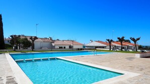A rectangular swimming pool with clear blue water, surrounded by a tiled deck. - The Moon Studio by Hello Homes Sitges (Sitges)