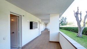 A corridor with a tiled floor, a door labeled "317", and a mailbox on the wall. - The Moon Studio by Hello Homes Sitges (Sitges)