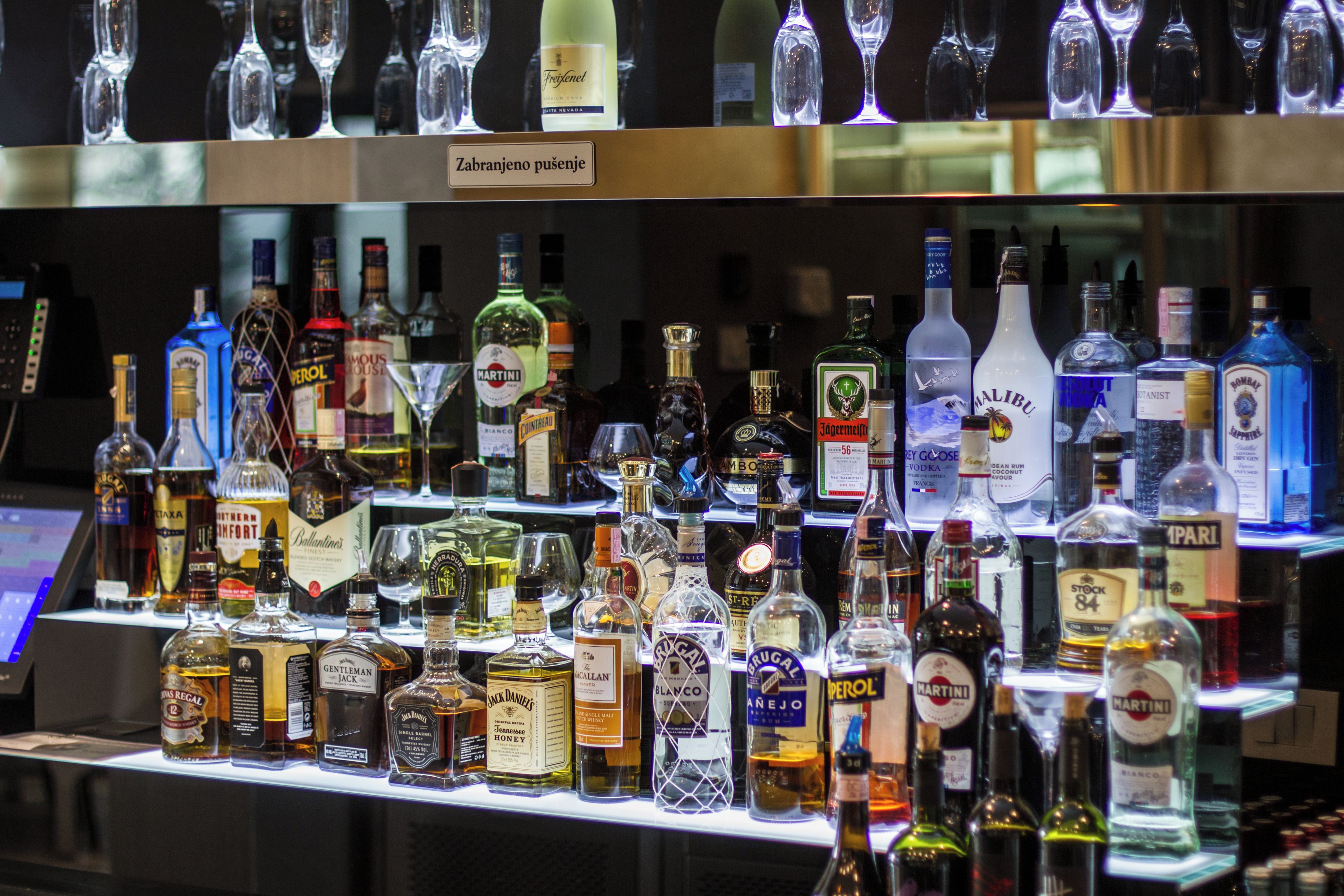 A bar with various liquor bottles and glasses.