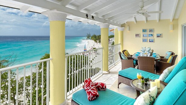 A balcony with a view of the ocean, wicker furniture, and a ceiling fan. - On Dover Beach, close to golf, surfing and much more. Discounts available (St-Lawrence Gap)