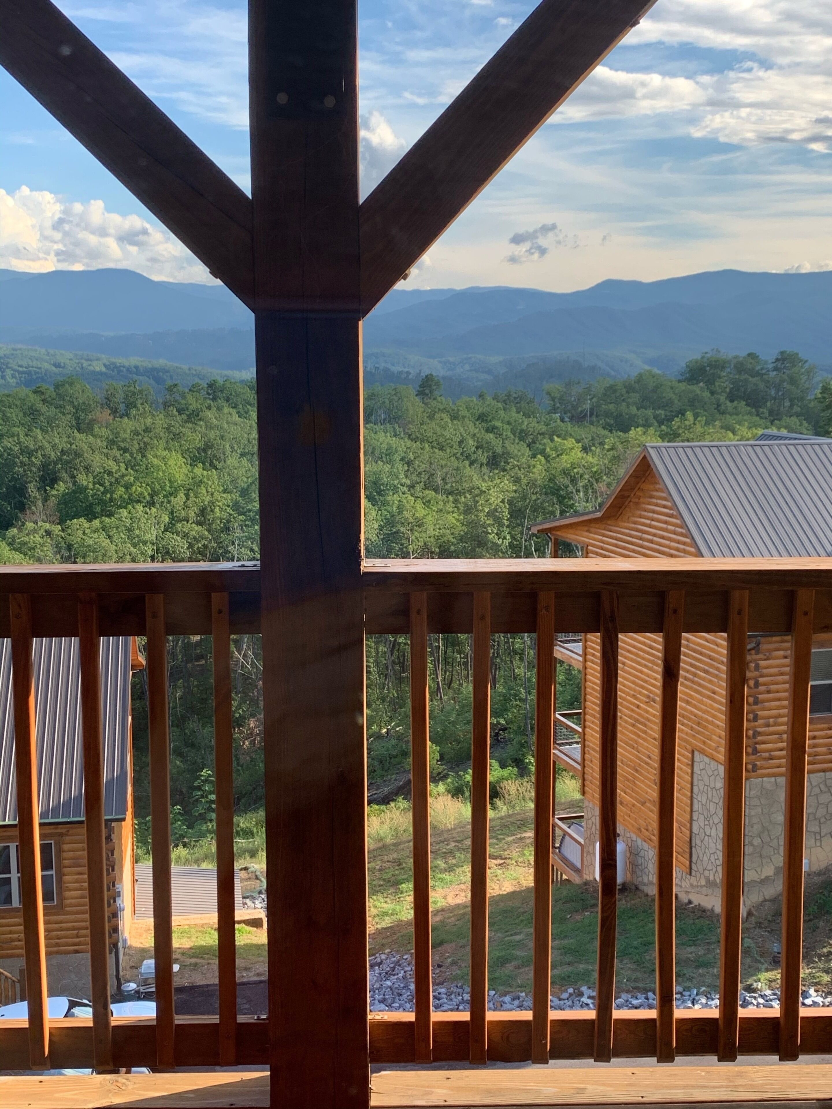 A wooden deck with a view of a mountainous landscape.