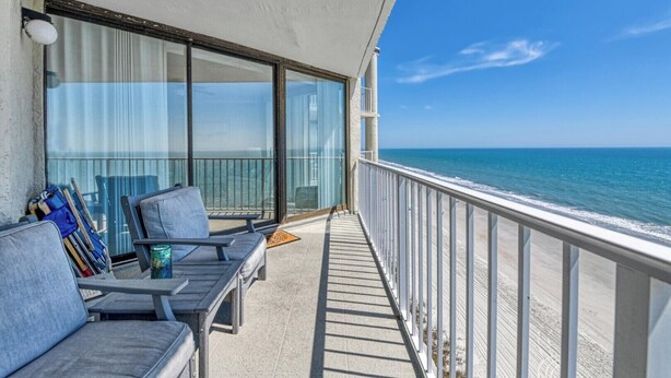 A balcony with a view of the ocean, a sofa, and a chair. - One Ocean Place 1102 2 Bedrooms, 2 Bathrooms, Oceanfront (Garden City Beach)