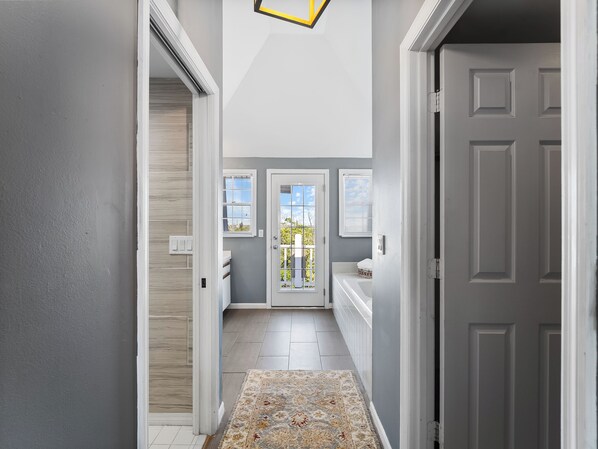 A hallway with a white door, a window, and a light fixture. - Island home bayside with sun decks on both sides C82C (Englewood)