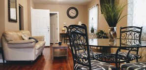 Relax in this stylish living room with a sofa, coffee table, and dining area.