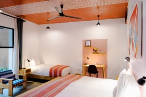 Relax in a spacious room with a large bed, desk, and comfortable chair.