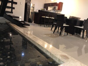 Enjoy meals in the adjacent dining area with a water feature nearby.