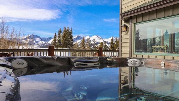 A hot tub with a view of snow-capped mountains. - Spacious. Private Hot Tub.Views. Deck. Pool Table. (Breckenridge)