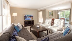 A living room with a sofa, armchairs, a coffee table, and a TV. - Open for the Holidays! Fireplace, Near XC skiing and Wineries, Good for Groups! (Leland)