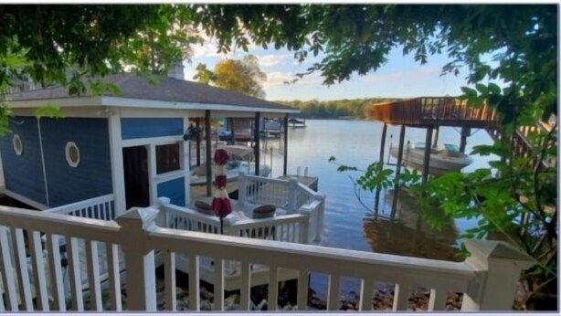 A dock with a small building, a covered seating area, and a view of the water. - Wifi, hot tub, pool table, air hockey, and fully loaded boat house!. This is Lake Lxury! (Moneta)