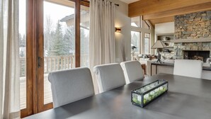 A dining area with a table, chairs, and a glass candle holder. - Elkhorn Summer Amenities and Mtn Views (Sun Valley)