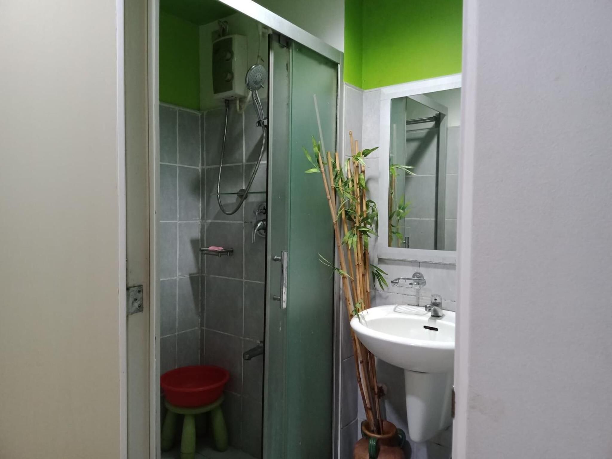 A bathroom with a shower, toilet, and sink.