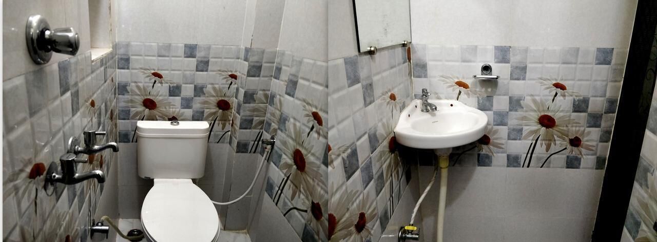 A bathroom with a toilet, sink, and shower.