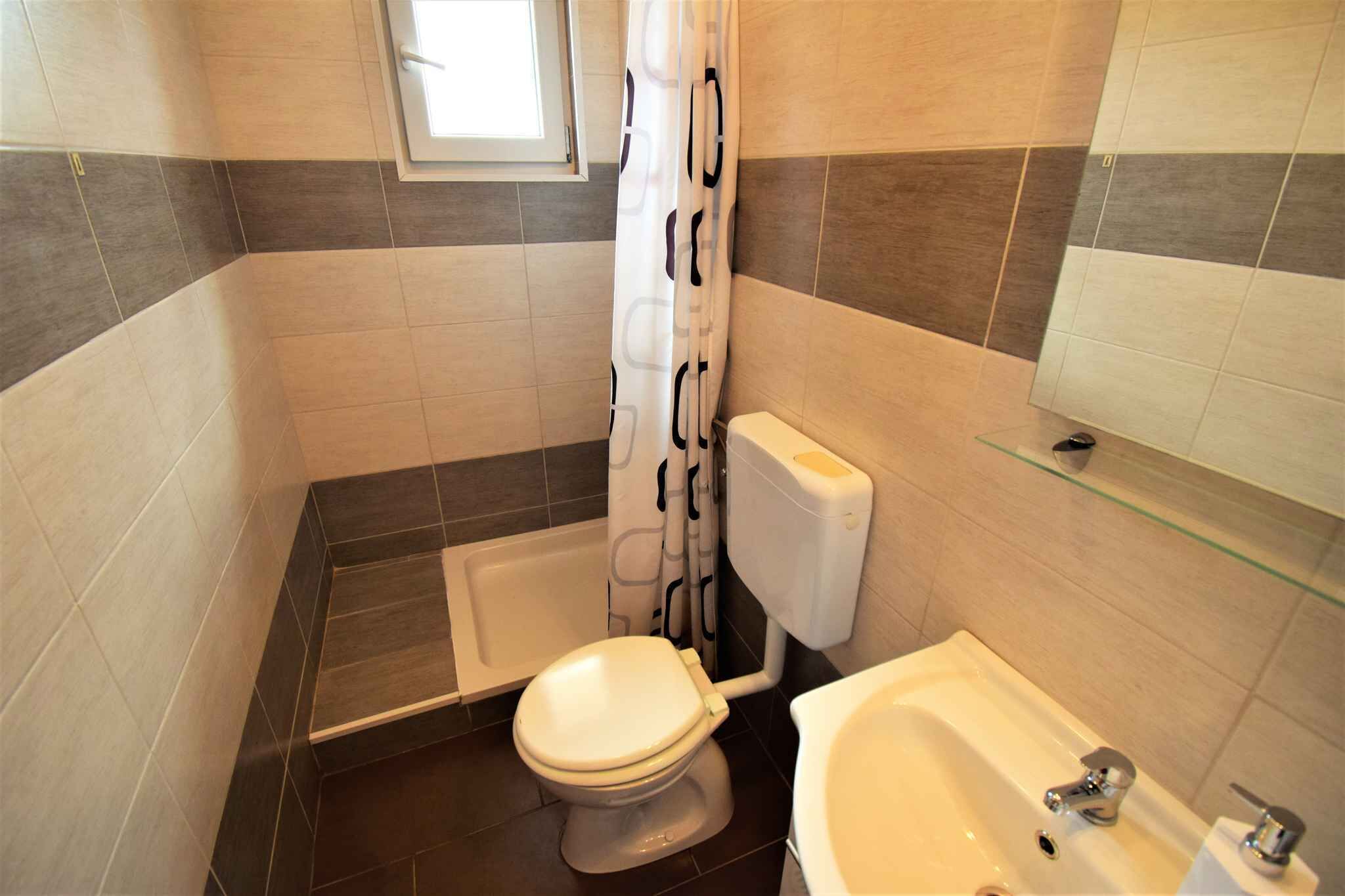 A bathroom with a toilet, bathtub, and sink.