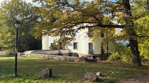 A building with a stone facade, a stone pathway, and a lamppost.