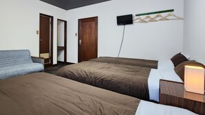 A hotel room with two beds, a TV mounted on the wall, and a wooden wardrobe. - Pension Kobekko (Otari)