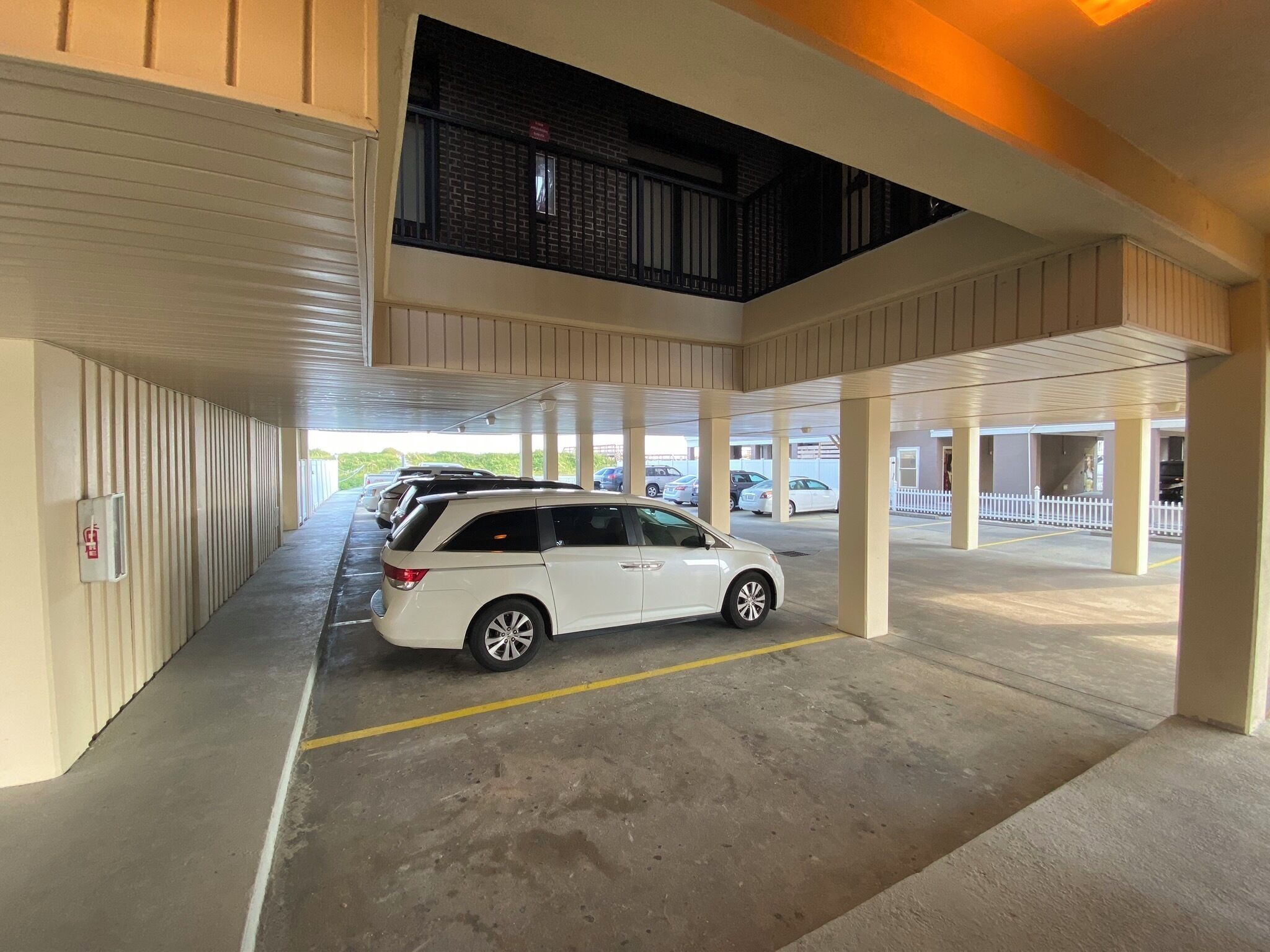 A multi-level parking garage with a white SUV parked in the lower level.