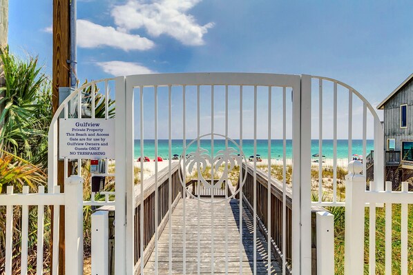 Enjoy beach access via a boardwalk and relax on the sandy shore with beach chairs and umbrellas.
