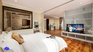 A hotel room with a large bed, a television, a desk, and a bathroom visible through an open door. - Sapa Green Hotel (Sa Pa)