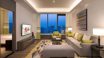 Deluxe Room, 2 Bedrooms | Living room | Flat-screen TV, DVD player