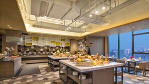 A modern kitchen with a central island, built-in shelves, and a large window offering a city view. - Citadines Gaoxin Xi'an (Xi'an)