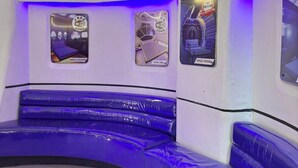 A curved seating area with a view of a space-themed wall, including a 'Free Wi-Fi Zone' sign and a 'Space Vessel' sign. - Astrotel Cubao (Quezon City)