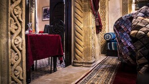 An interior with a dining area, a patterned rug, and a traditional sofa. - Riad La Porte Du Bouregreg (Salé)