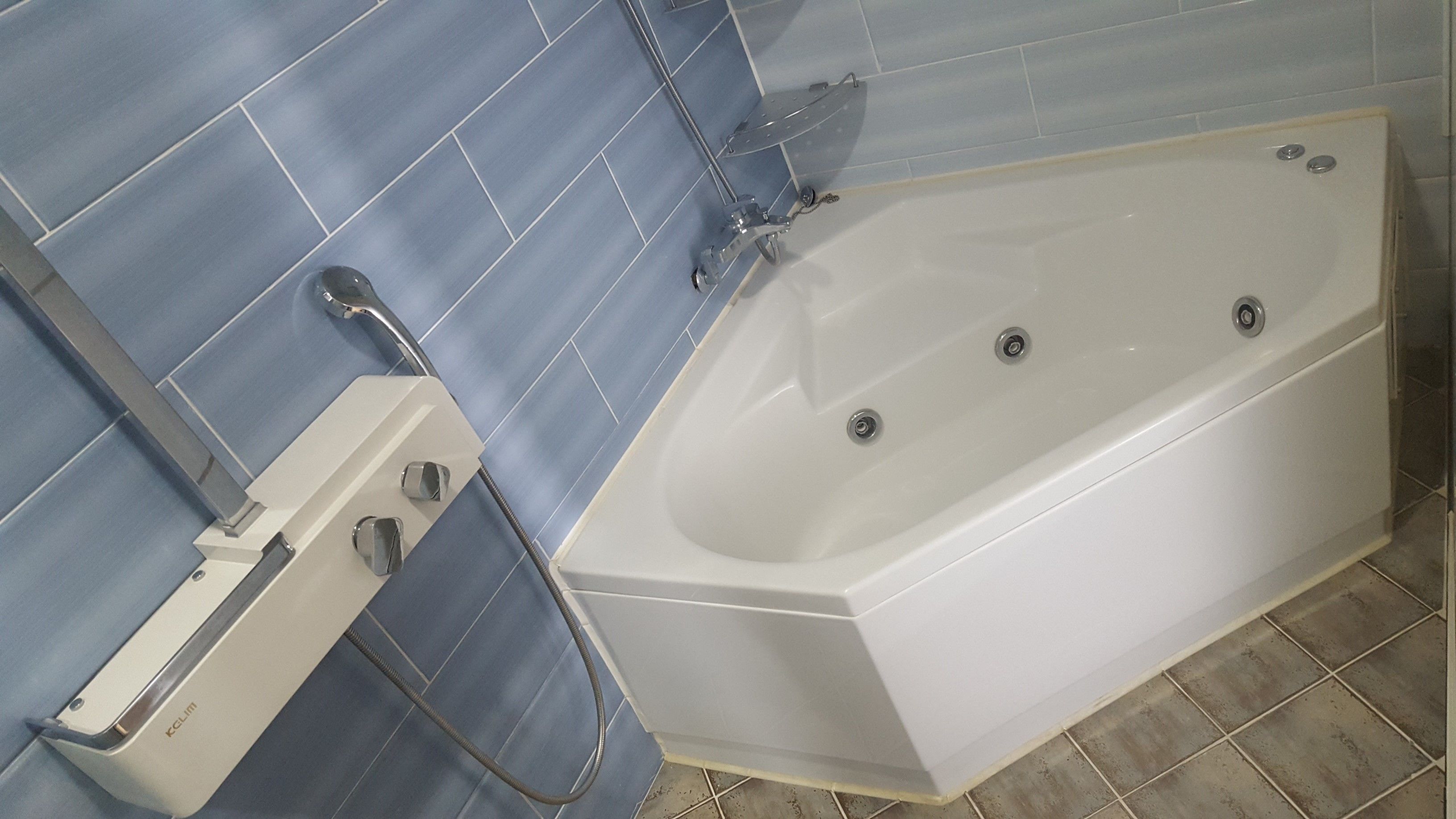 A bathroom with a bathtub, a shower, and a toilet.