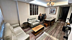 A modern living room with a sofa, coffee table, and a dining area with a table and chairs. - Tainan Anping High Chill B&B (Tainan)