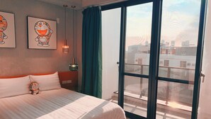 A bedroom with a large bed, a window with curtains, and artwork on the wall. - Tainan Anping High Chill B&B (Tainan)