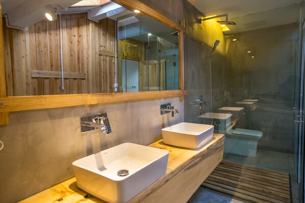 A modern bathroom with two sinks, a large mirror, and a glass shower enclosure. - Maosao Inn (Zhangjiajie)