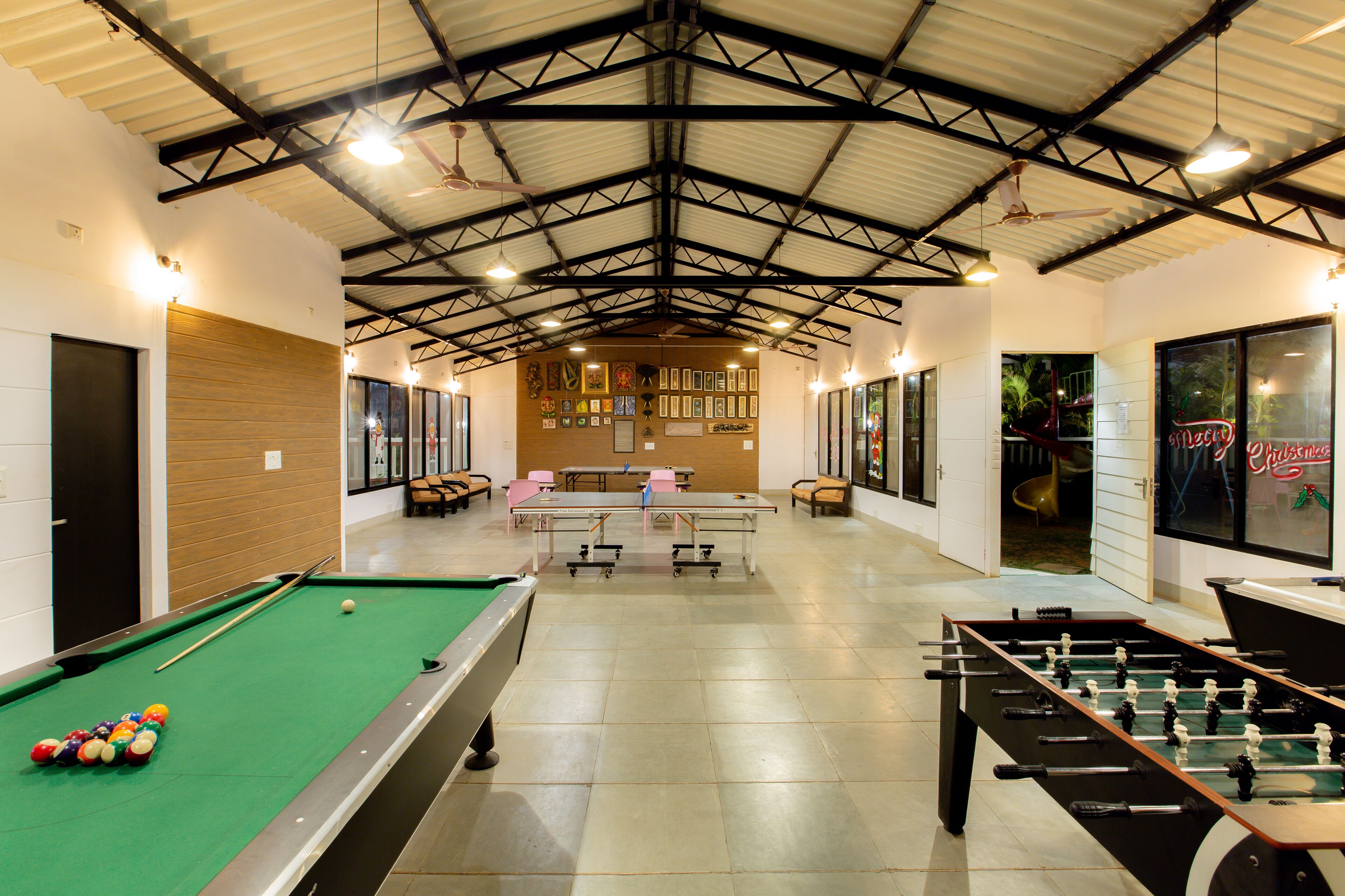 A recreational area with a pool table, foosball table, and billiards.