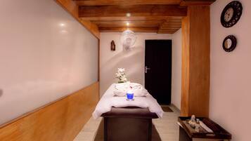 Relax in a serene hallway leading to a peaceful retreat, featuring a bench and a wooden chest with amenities.