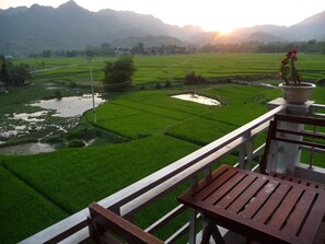 Relax on the terrace with a serene view of the lush rice paddy field and rolling hills.