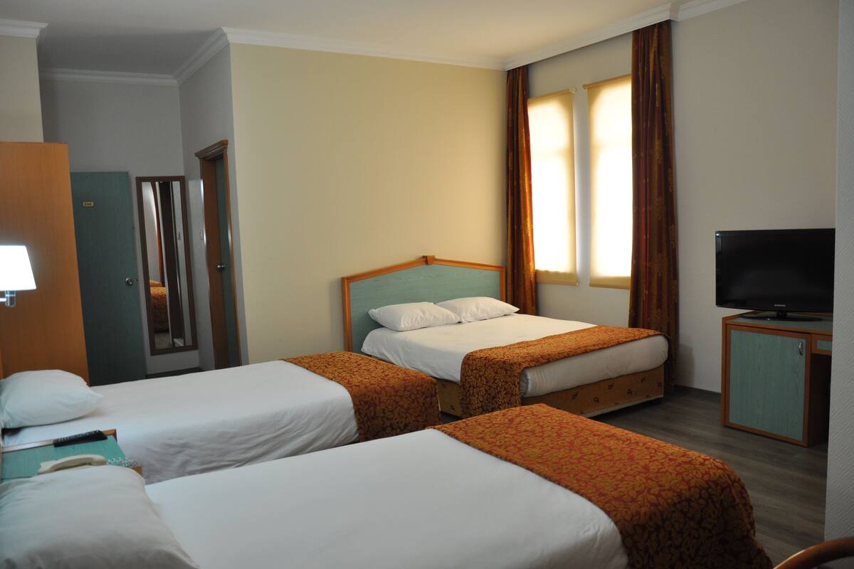Standard Triple Room | Minibar, in-room safe, desk, iron/ironing board