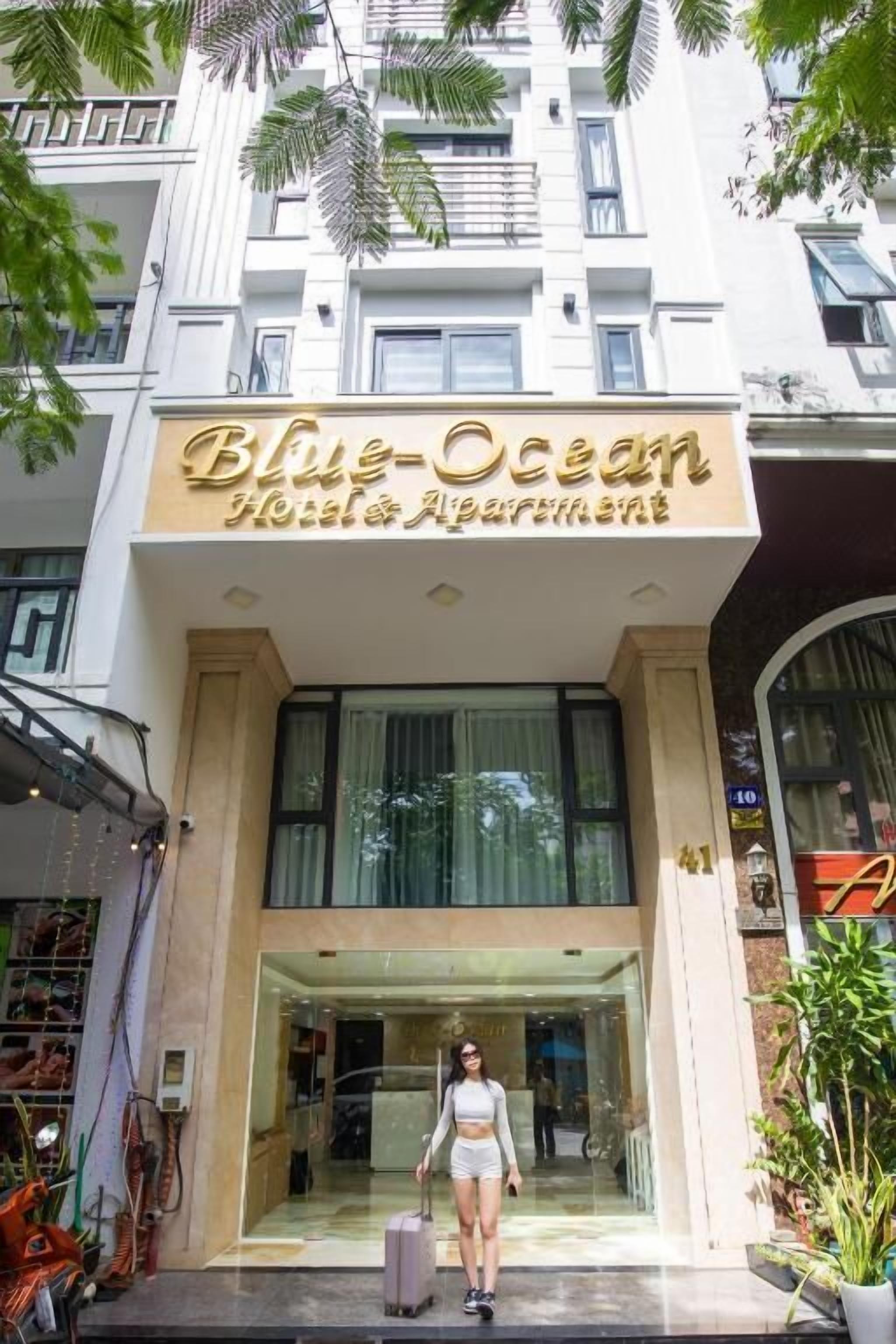 The Blue-Ocean Hotel's entrance with a modern facade, large windows, and a welcoming entrance.