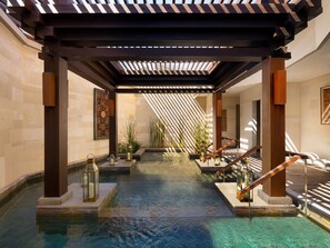 A spa area with a wooden pergola, a small pool, and a staircase leading to a higher level. - Six Senses Bali (Pecatu)