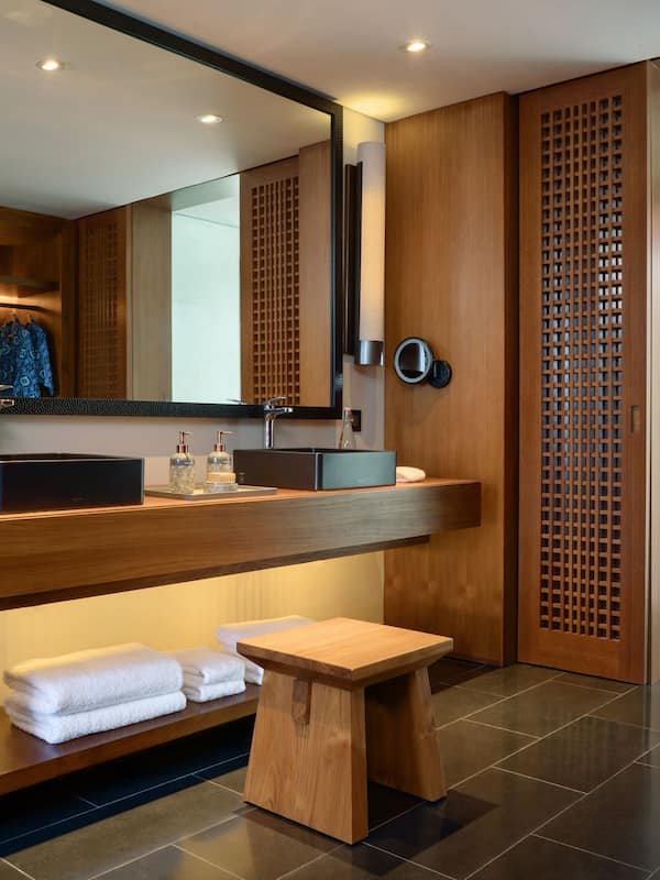 Features a sleek vanity, sink, and glass shower enclosure.