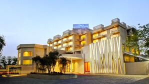 A modern hotel with a prominent sign reading "SAROVAR PREMIERE" and a well-lit entrance. - Sarovar Premiere Jaipur (Jaipur)