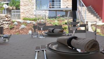 A table set for two with wine glasses, plates, and cutlery.