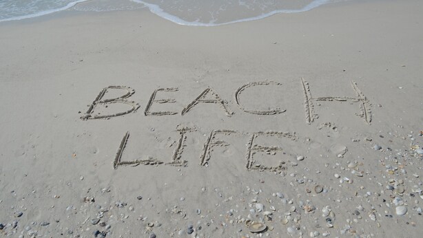 A beach with the words "BEACH LIFE" written in the sand. - Welcome to Beach Basket – Your Seaside Retreat!" (Anna Maria)