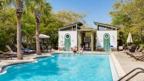 Zona de piscina con sillas de descanso, piscina y edificio con puerta verde y un letrero que dice 'No Diving Allowed'.