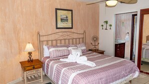 A neatly made bed with patterned bedding and two towels folded in the center. - Sonoran Spa W403 - 2 BR Next to the Pool, High Speed Wi-Fi - Beachfront Upper Floor Luxury Condo (Puerto Peñasco)