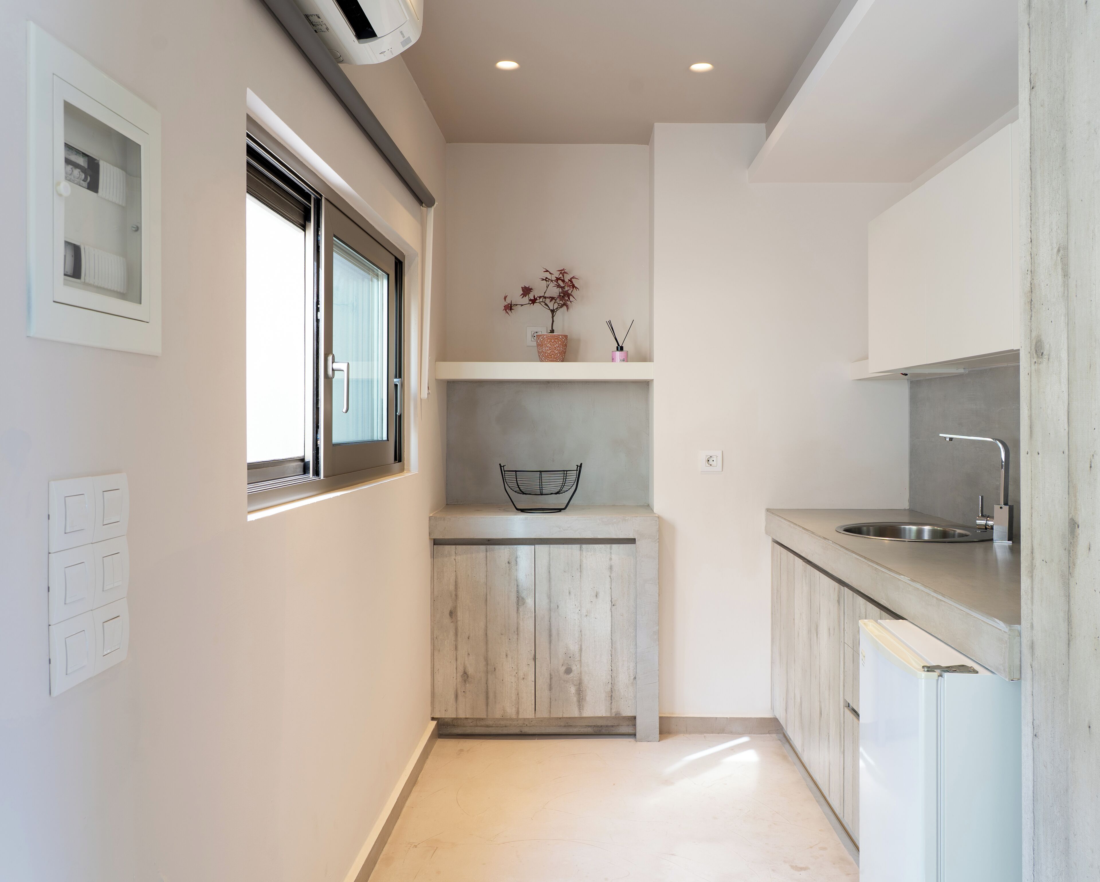A compact kitchen with a window, a sink, and a small countertop.